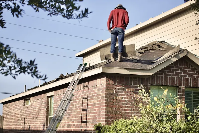 Professional roofer working on a residential roof in Great Falls Crossing